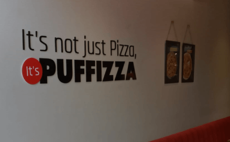 Puffizza Tagline on wall of Puffizza's Store
